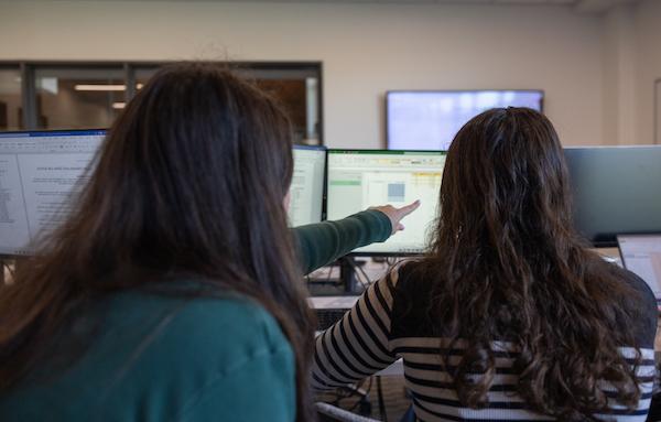 Students discussing in the trading lab